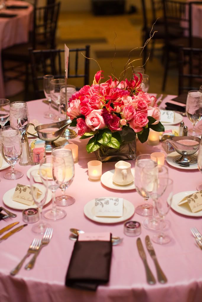 tall centerpieces bursting with roses ranunculus and gloriosa lilies 